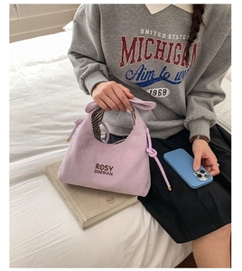 Close-up of lavender bucket bag with drawstring knot and Rosy Doedian branding detail