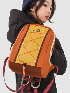 Contrast color drawstring backpack with orange cords for hiking and travel use