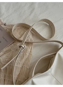 Detail of adjustable shoulder strap and smooth texture on beige minimalist tote bag