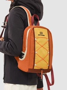Three-color drawstring backpack with orange and yellow panels and mesh side pockets