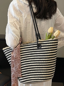 Handmade woven tote bag with black and white stripes and a stylish silk scarf handle