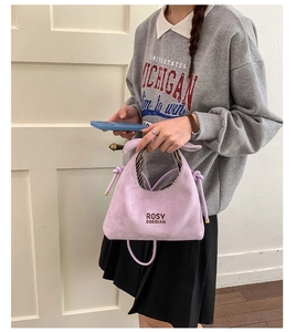 Purple suede bucket bag with knotted handle detail and ROSY DOEDIAN logo engraving