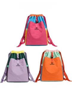 Lightweight nylon backpacks in three colorblock options with drawstring closure and buckle