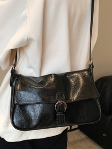 Fashionable black glossy leather crossbody bag for women with elegant golden metal ring buckle