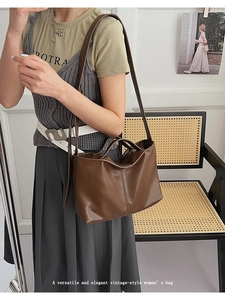Detail view of the deep brown vintage leather shoulder bag with textured vertical seams