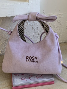 Lavender purple suede bucket bag with bow handle and crossbody strap for women