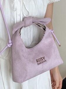Chic lavender suede handbag with bow knot handle and brand logo for fashion commute