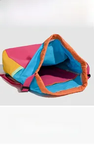 Detail view of the large interior compartment of the colorful nylon drawstring backpack
