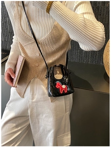 Détail du mini sac à bandoulière matelassé noir brillant avec broderie de poney rouge
