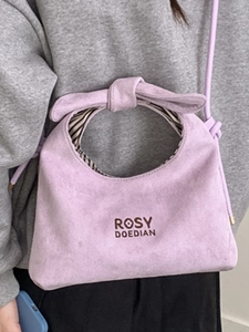 Chic light purple suede handbag with bow handle and adjustable crossbody shoulder strap