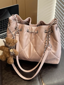 Pink quilted shoulder bag with silver chain and cute brown plush bear charm