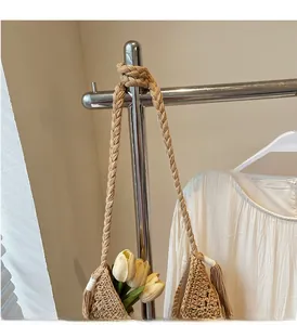 Detail of khaki hand-woven tote bag showing chunky rope handle and intricate knit pattern