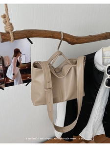 Detail shot of khaki vintage tote bag with vertical stitching on natural wood stand