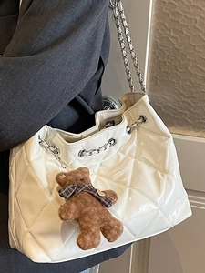 Chic retro white quilted shoulder bag with chain strap and cute bear charm accessory