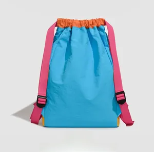 Detail view of colorful nylon backpack showing contrast straps and adjustable buckles