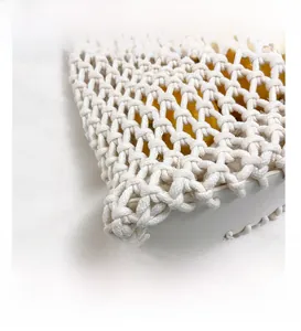 Detailed close-up of handmade woven mesh bag with cotton rope and white leather base