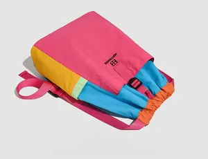 Detailed flat lay of colorful nylon drawstring backpack with multi-color patchwork panels