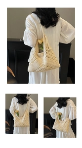 Detail of beige hand-crocheted hobo bag with hollow weave patterns and stylish tassels
