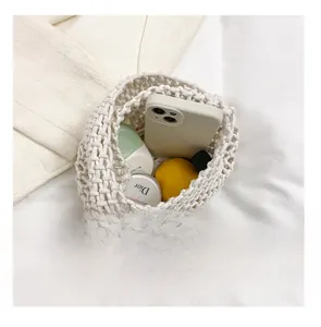 Detail presentation showing storage capacity of a white woven cotton bucket handbag