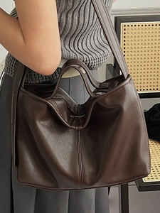 Classic dark brown leather tote bag with soft texture and wide shoulder strap