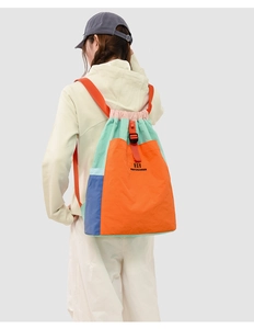 Macro shot of hiking backpack showing colorful contrast stitching and drawstring closure