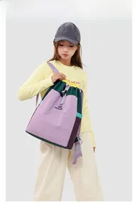 Detail view of the colorful drawstring backpack showing adjustable straps and fabric texture
