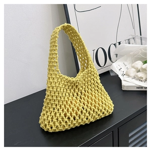 Detail of handwoven ginger yellow hollow crochet handbag with thick cotton rope texture