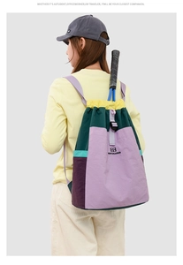 Detail of multi-color block patchwork backpack with drawstring closure for hiking and travel