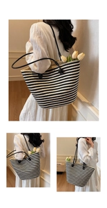 Close-up of black and white striped woven tote bag with leather straps and tulip decor