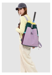 Detail of color-block drawstring backpack with large capacity holding a tennis racket