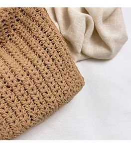 Detail of hand-woven brown tote bag showing intricate crochet texture and natural material