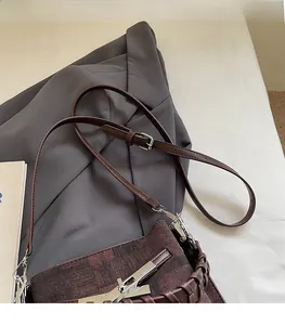 Detail of a vintage dark brown bucket bag featuring woven handle and silver hardware