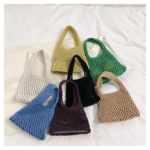 Macro view of assorted colorful handmade cotton woven hollow tote bags in various vibrant colors