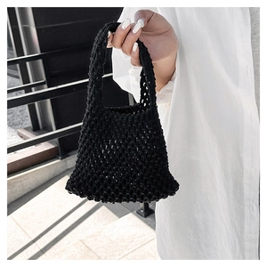 Close-up of a black handmade crochet woven tote bag with a minimalist hollow pattern