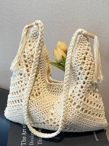 Beige hand-crocheted woven tote bag with tassels and tulips inside for beach style
