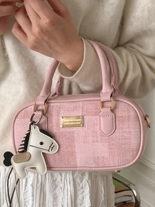 Pink and white woven Boston handbag with leather trim and decorative pony charm