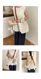 Detail view of cream woven tote bag with brown leather strap in a minimalist setting