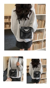 Detail of grey pixelated pattern bucket bag with silver buckle and braided handle