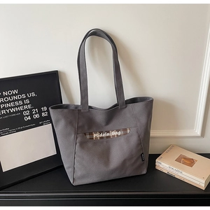 Vista dettagliata di una borsa tote in tela grigia con tasca a scacchi e logo Midolai