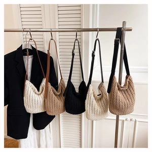 Detail view of woven tote bags in multiple colors featuring adjustable leather straps