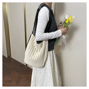 Chic beige woven tote bag with hollow knit texture and black shoulder straps