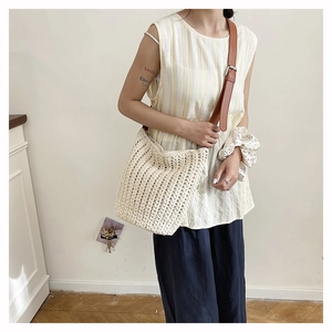 Detail of crochet knit tote bag with premium brown leather adjustable shoulder strap