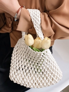 Elegant white hand-woven crochet tote bag featuring hollow mesh texture and rope handles