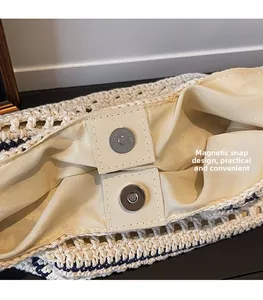 Detail showing inner fabric lining and silver magnetic buckle of the woven bucket bag