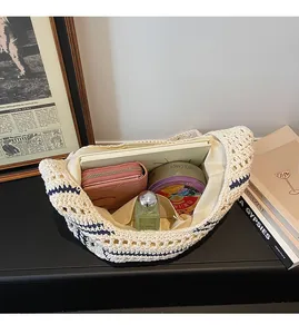 Detail view showing large interior capacity of the beige crochet woven shoulder bag