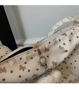 Close-up of corduroy tote bag detail with sweet girl print and metal zipper slide