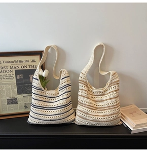 Detailed view of handmade crochet striped tote bag with hollow woven texture and wide strap