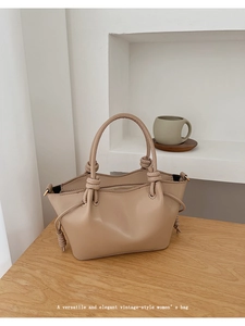 Macro shot of knot handle details and smooth synthetic leather on the vintage bag