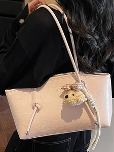 Pink glossy faux leather tote bag with shoulder strap and plush bear charm for daily use