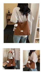 Detail of brown corduroy tote bag with heart patterns and plush cloud keychain accessory
